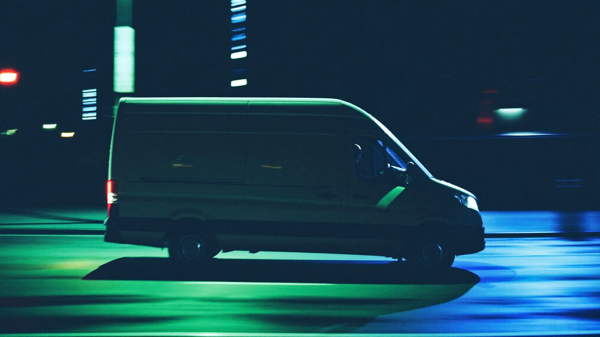 Courier van on a wet Charlotte street at night